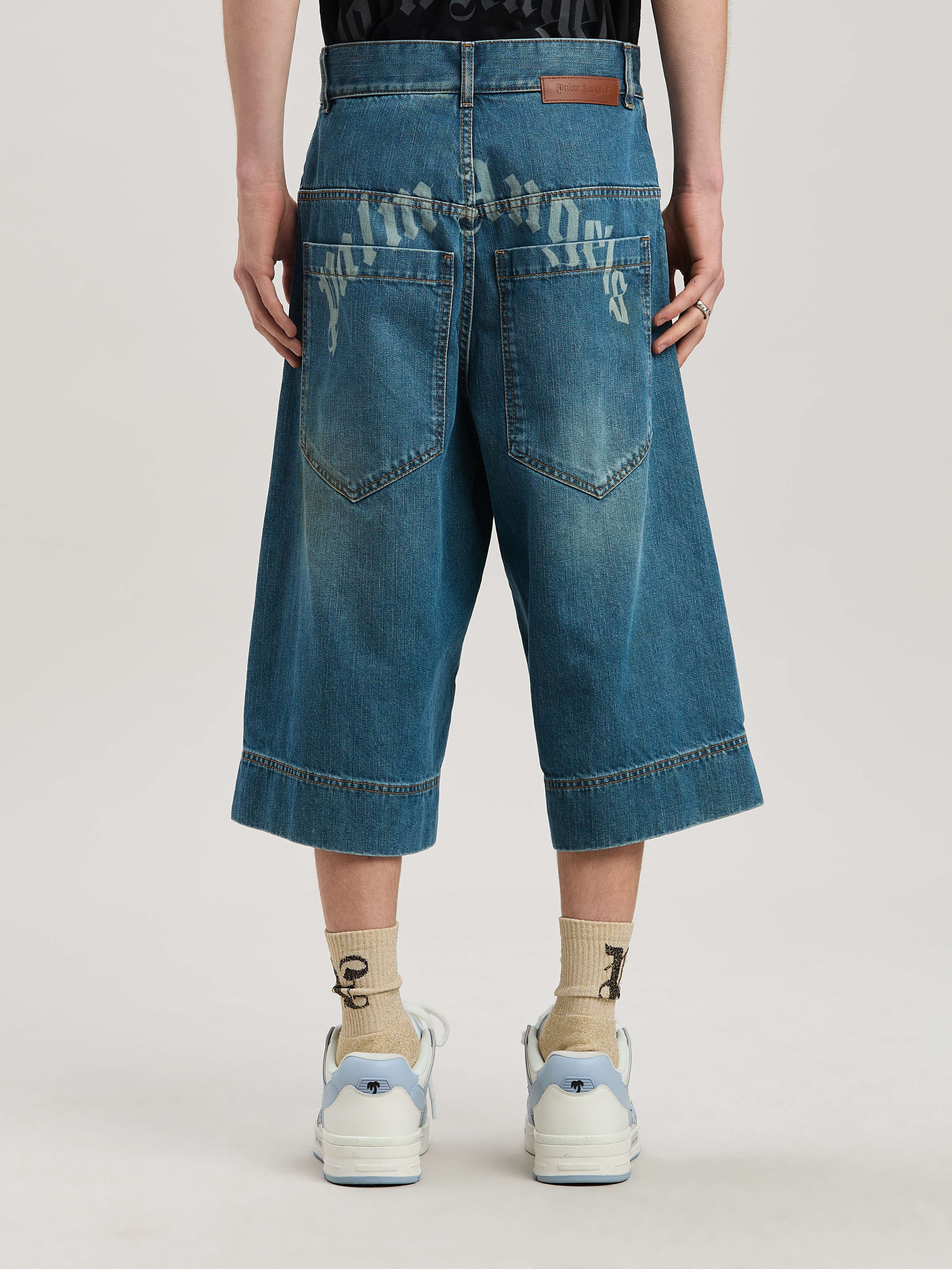 PALM ANGELS  G CURVED LOGO DENIM SKATER BLUE - GREEN PMYC007S25DEN001